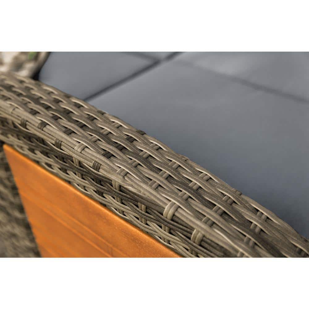 Close-up of the woven wicker armrest and dark gray cushion of the day bed.