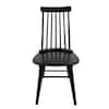 Front view of an antique black wood slat dining chair.