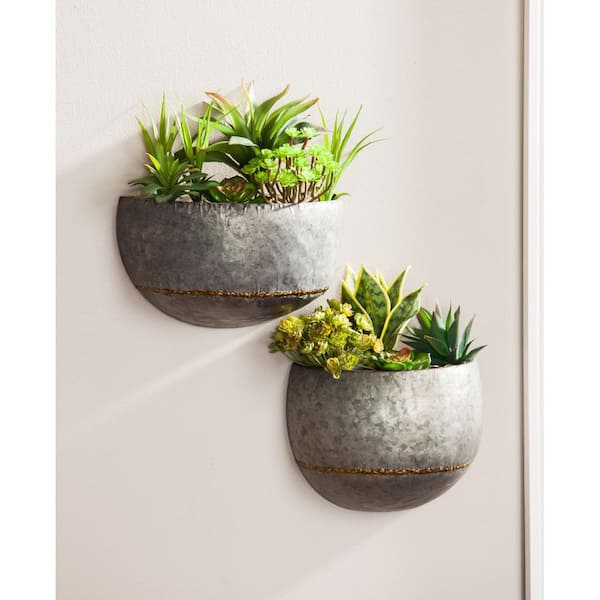 https://images.thdstatic.com/productImages/012cf769-12c1-4749-b6b2-0c4ed5637376/svn/silver-evergreen-wall-planters-8pmtl053-c3_600.jpg