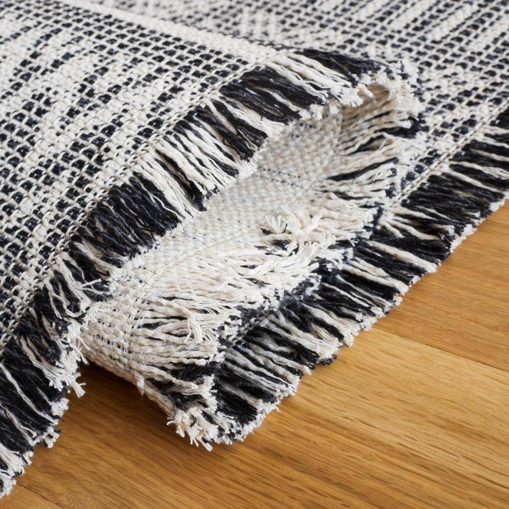 Augustine Black and Ivory Geometric Synthetic Area Rug, 6'4" x 9'6"