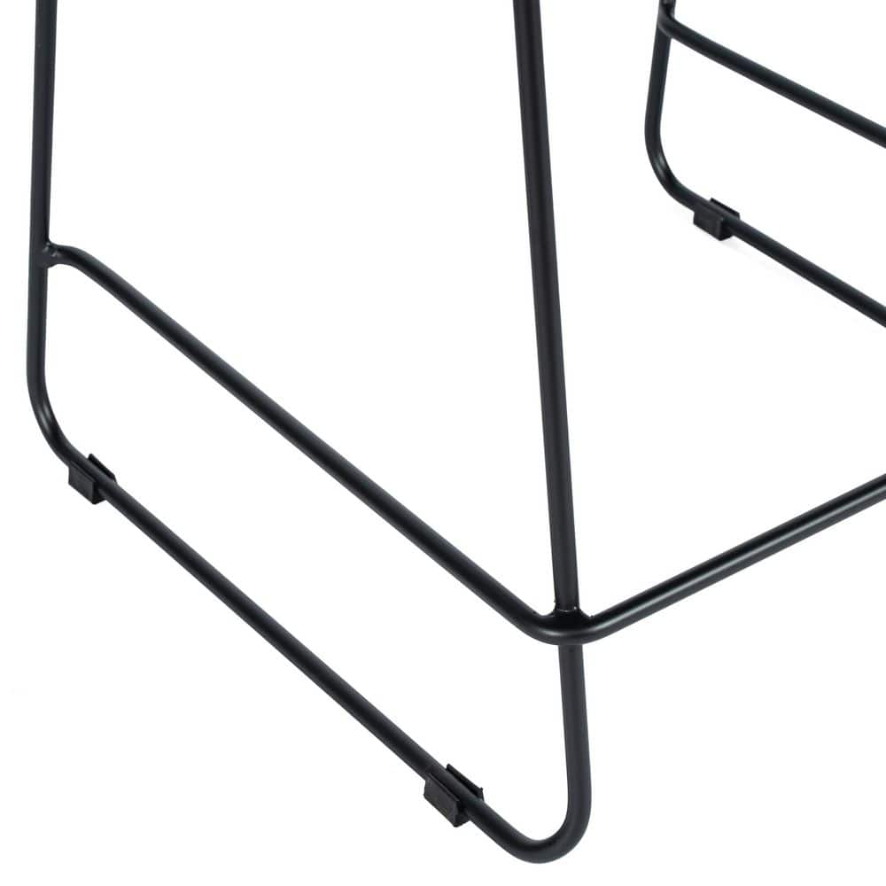 Close-up of the black metal sled base and plastic floor glides of a stool.