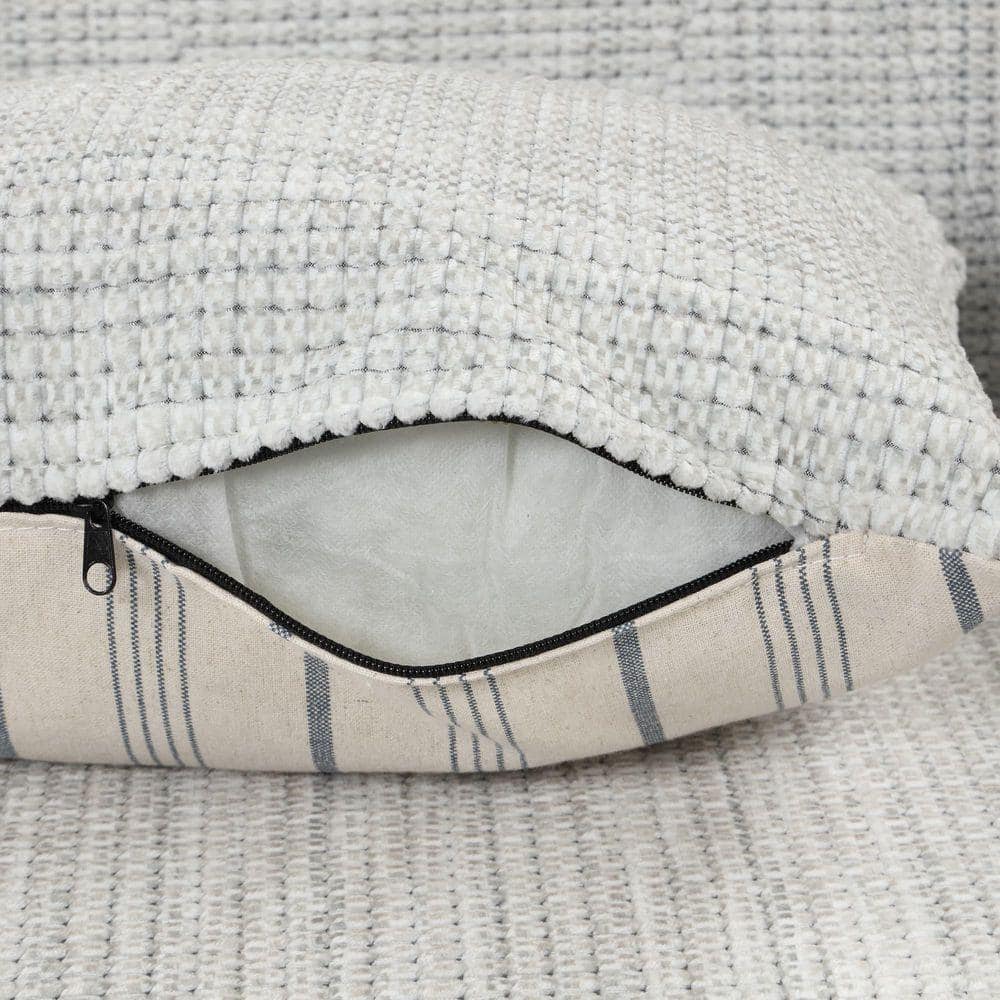 Close-up of the textured chenille fabric and zipper detail on the sofa arm.
