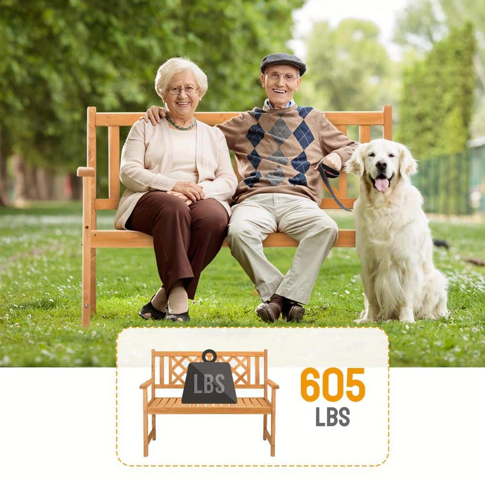 Two elderly people sitting on a brown wooden outdoor bench with a dog beside them.