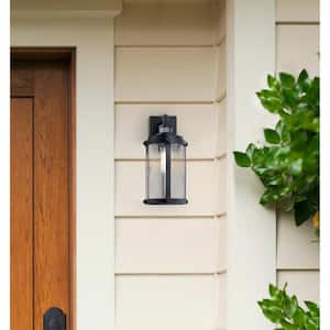 Armin 1-Light Textured Black Motion Sensing Outdoor Wall Lantern Sconce with Clear Ribbed Glass