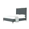 Three-quarter view of a gray velvet upholstered platform bed with white bedding.