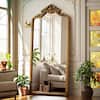 XRAMFY Antique Gold 32 in. W x 71 in. H Arched PU Frame with Ornate Carved Decoration Full Length Mirror Floor Mirror FMPUAC053271GD