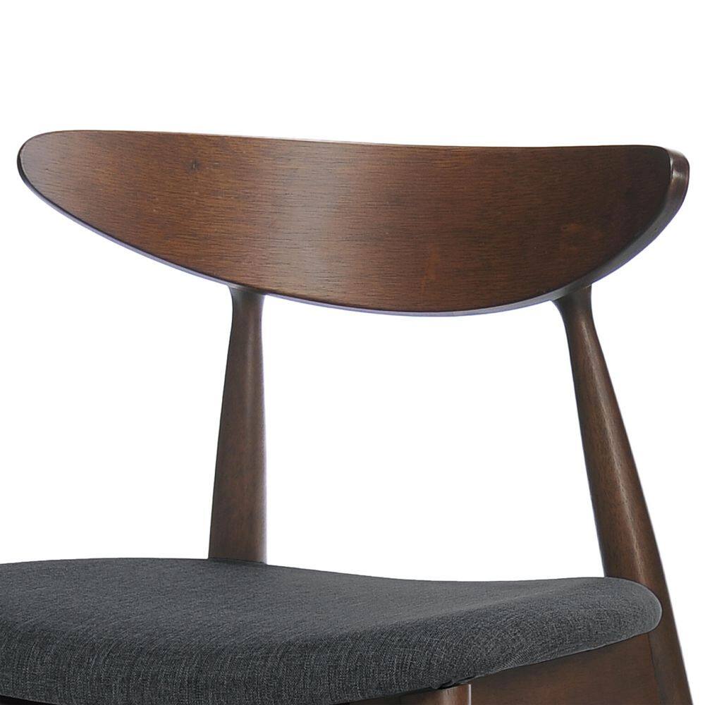 Close-up of the curved walnut wood backrest of a dining chair.