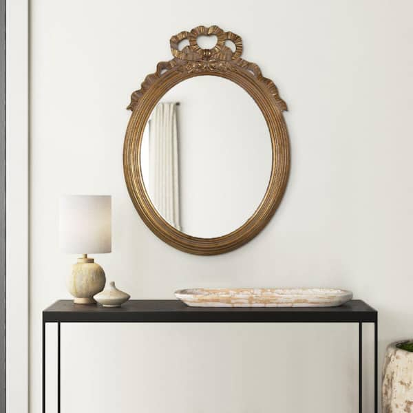 18.5 in. W x 26 in. H Gold Ornate Polyresin Floral Crest Wall Accent Mirror