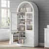 White arched storage cabinet styled in a modern room.