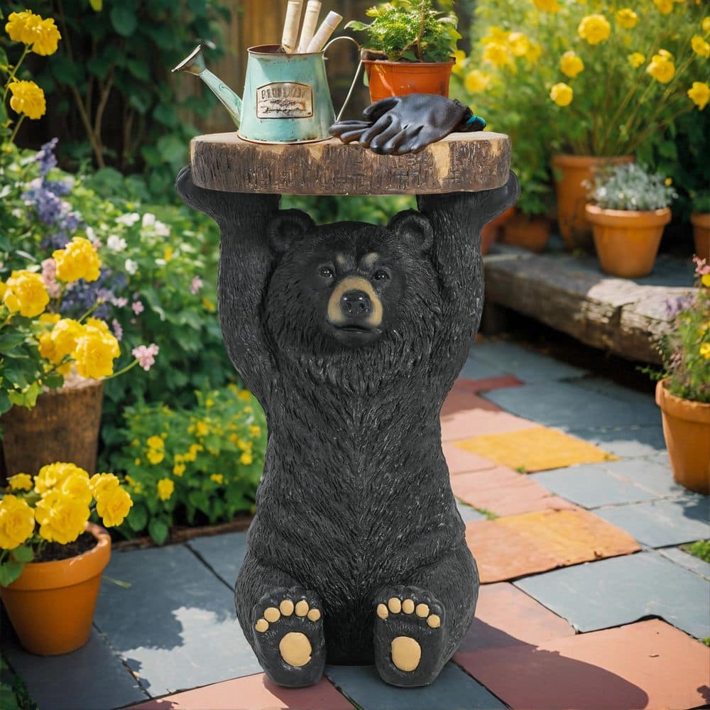 Black bear side table in a garden setting.