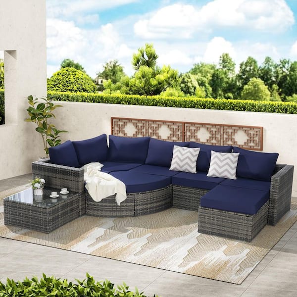 8-Piece Rattan and Metal Outdoor Sectional Set Curved Glass Top Table with Dark Blue Cushions