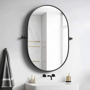 23 in. W x 31 in. H Oval Metal Framed Pivoted Bathroom Wall Vanity Mirror in Black