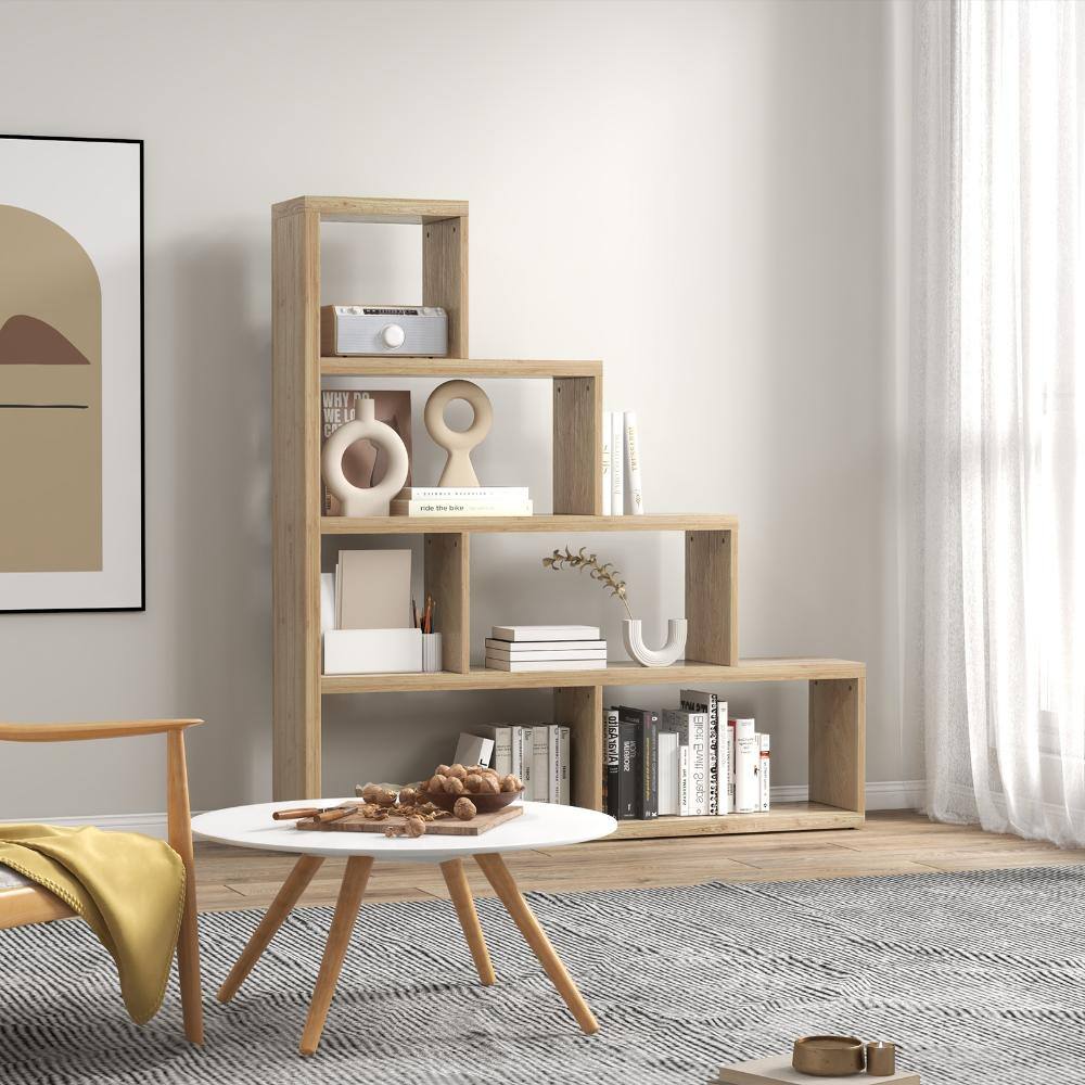 A natural wood stepped bookcase in a living room setting.
