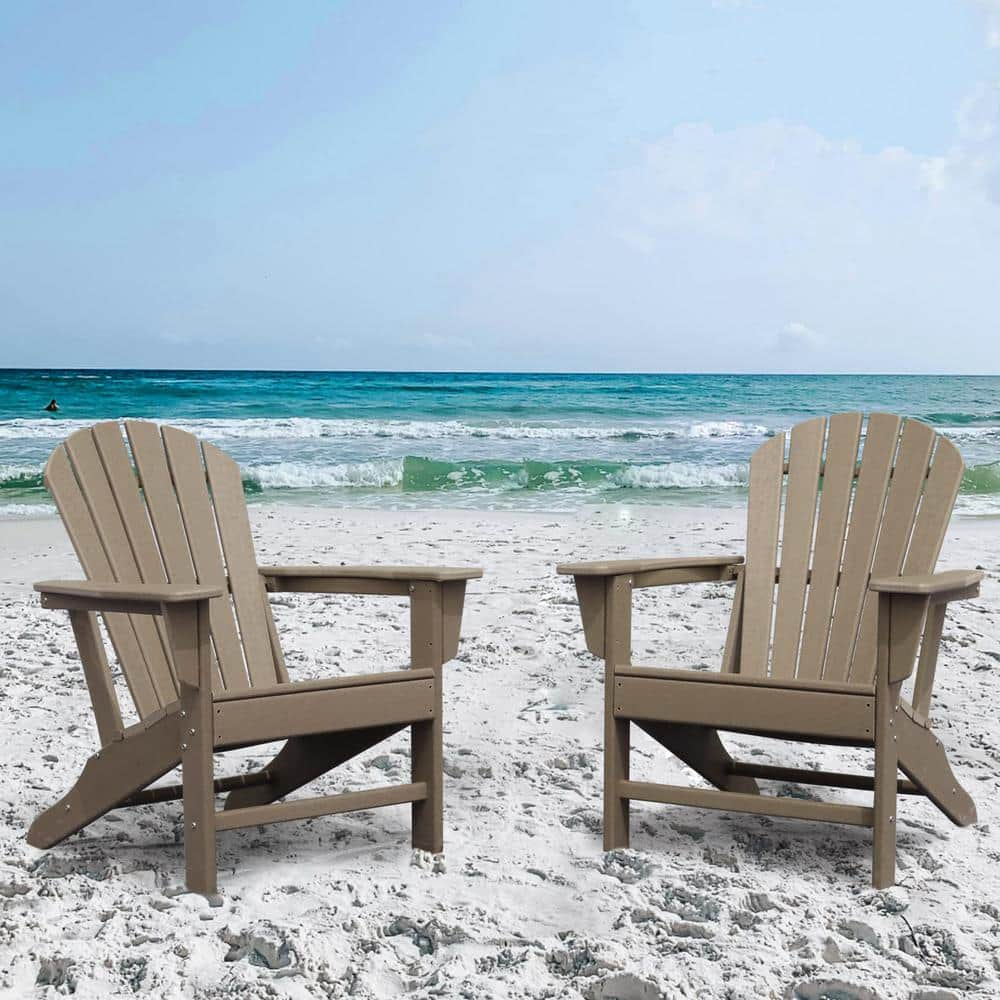 two adirondack chairs on the beach