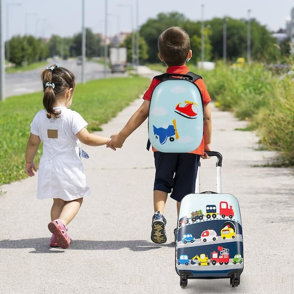 Little boy rolling discount suitcase