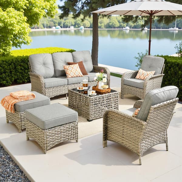 Eliza 6-Piece Outdoor Wicker Conversation Sofa Seating Set for Patio, with Ottoman, Dark Gray Cushions and Coffee Table.