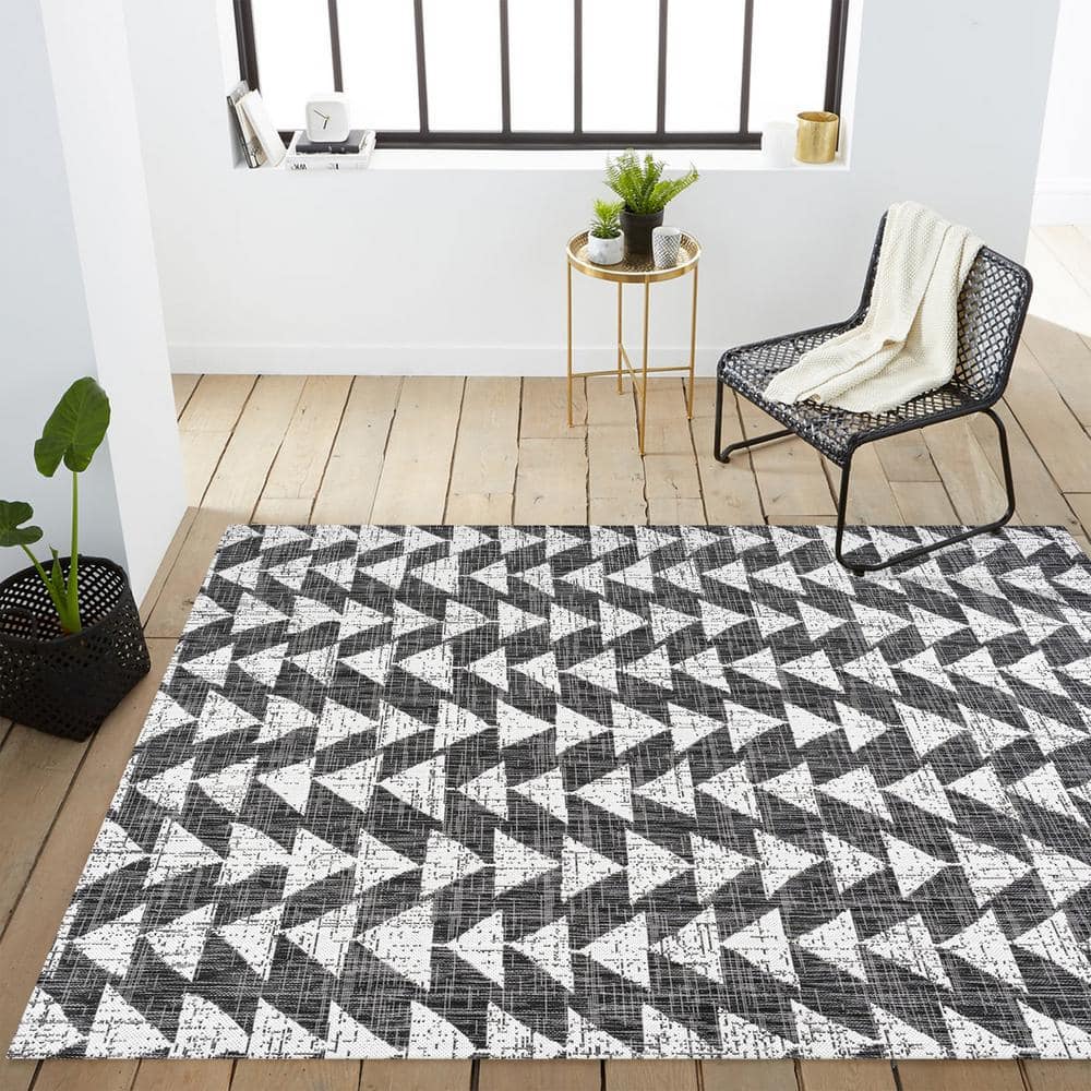 5' x 8' Black and Ivory Geometric Synthetic Area Rug