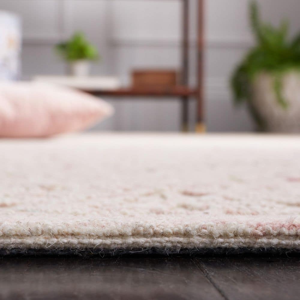 Ivory and Pink Hand Tufted Wool 6' x 9' Area Rug