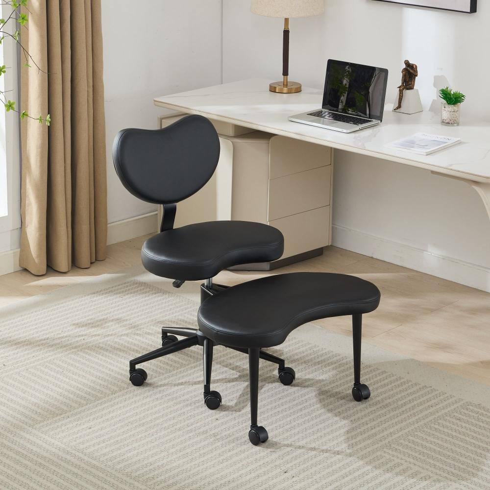 Black PU leather gaming chair and stool set in a home office setting.
