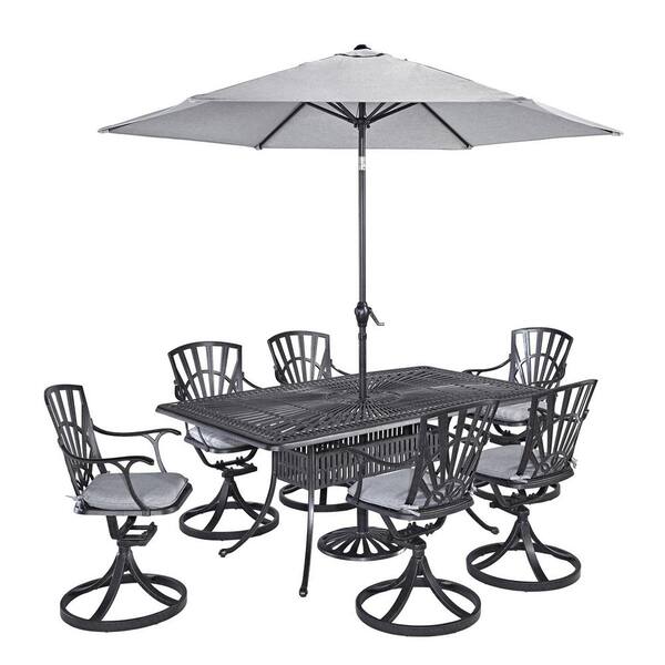 HOMESTYLES Grenada Charcoal Gray 7-piece Cast Aluminum Rectangular Outdoor Dining Set with Umbrella with Gray Cushions