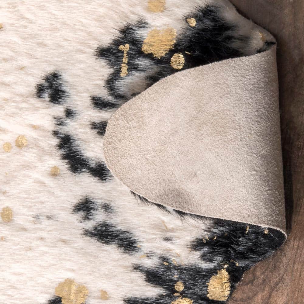 Black and Ivory Tufted Synthetic Cowhide Shaped Area Rug