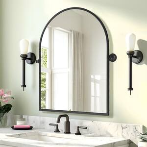 24 in. W x 32 in. H Arched Metal Framed Pivoted Bathroom Wall Vanity Mirror in Black