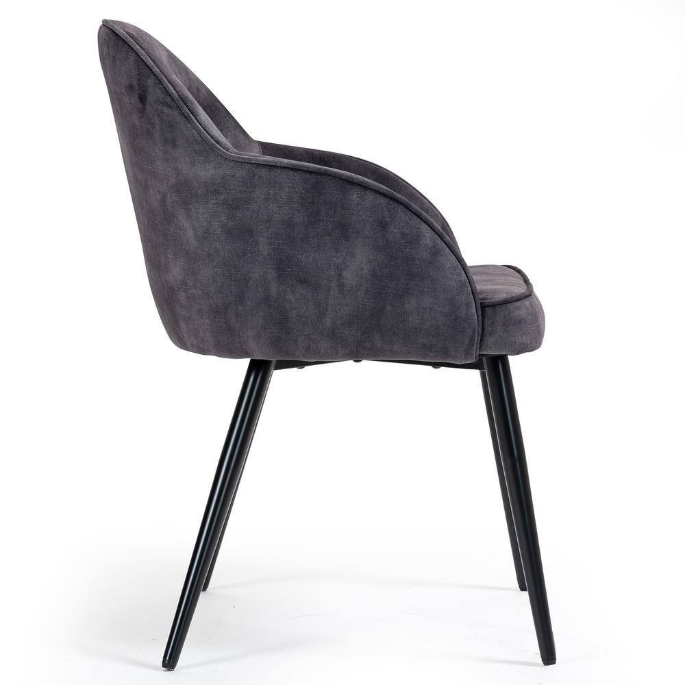 Gray velvet dining chair viewed from the side against a white background.