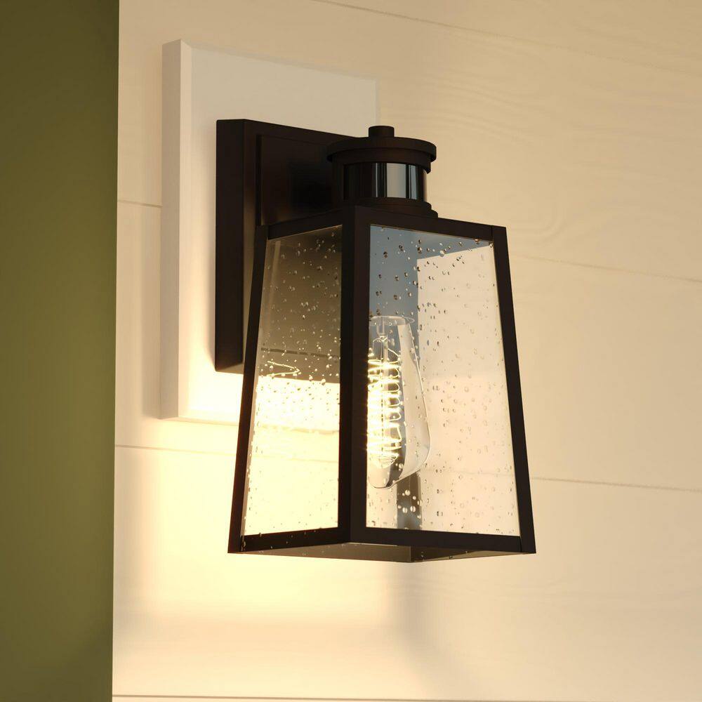 Sutton 12.25 in. H Black Motion Sensor Dusk to Dawn Outdoor Hardwired Sconce Wall Light, Clear Seeded Glass price history on PriceWatchPro