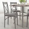 Gray X-back dining chairs placed around a round table.