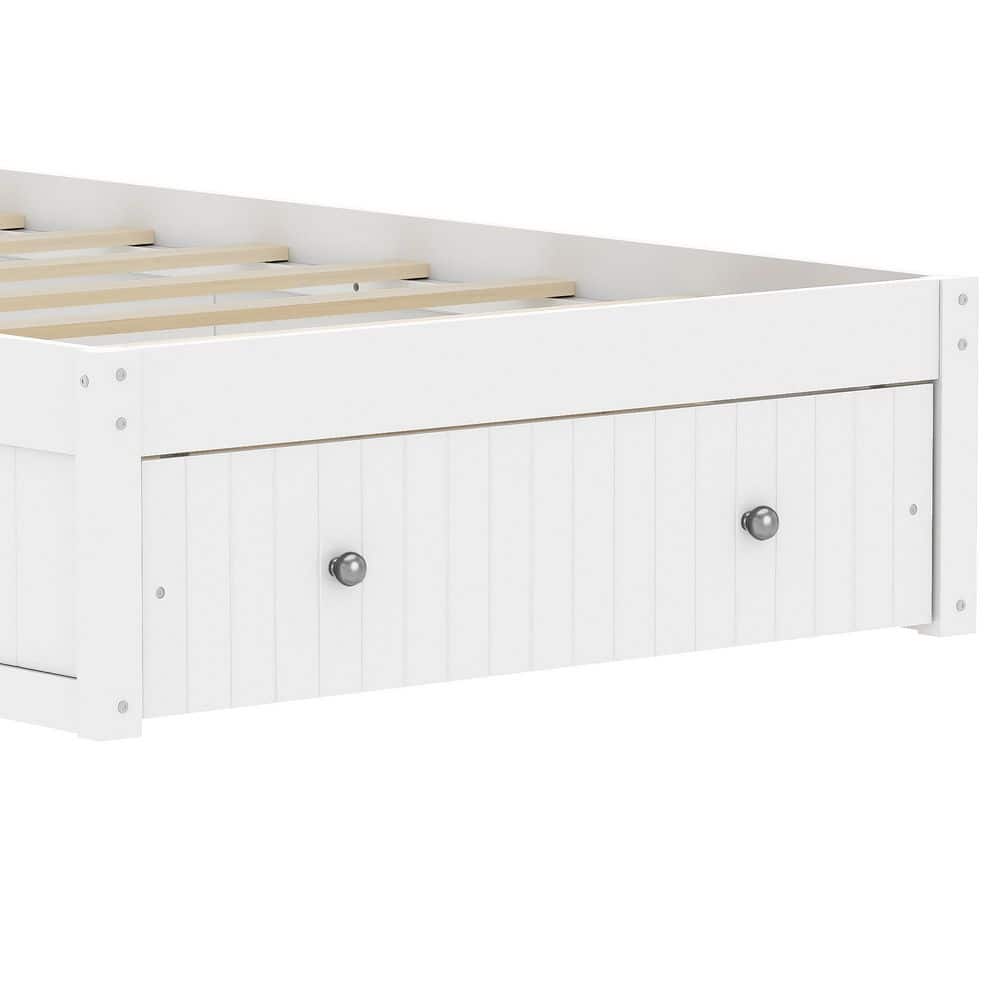 Close-up of a storage drawer on a white wooden bed frame.