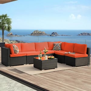 7-Piece Black Wicker Outdoor Sectional Sofa Set with Orange Cushions and Ottomans