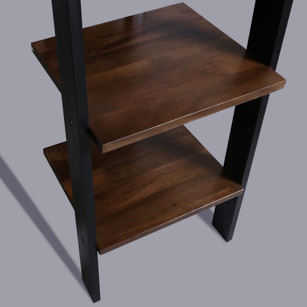 Close-up of the walnut shelves and black frame of the ladder bookcase.