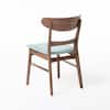 Single wooden dining chair with curved backrest and blue seat.