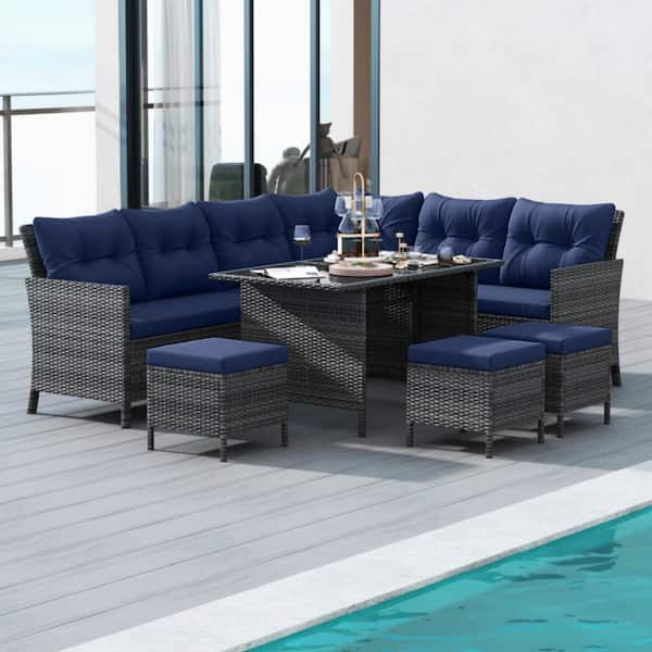 7-Piece Wicker Outdoor Dining Set with Navy Cushions and Ottomans