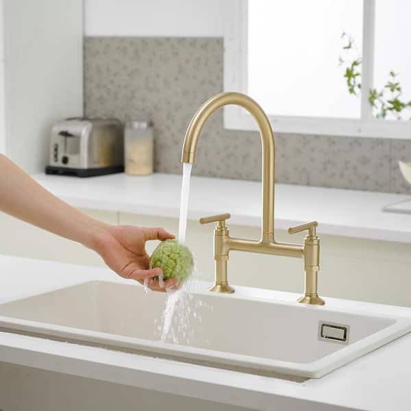 Double-Handle Bridge Kitchen Faucet with 360° Swivel Spout and Solid Brass Construction in Brushed Gold