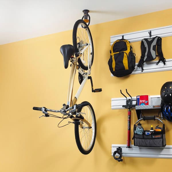 Move ceiling hooks to wall bike supported by only one hook -- and it  means room for many bikes