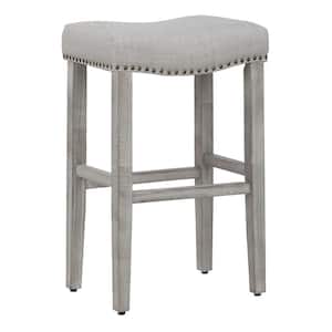 Jameson 29 in Bar Height Antique Gray Wood Backless Nailhead Trim Barstool with Upholstered Gray Linen Saddle Seat Stool