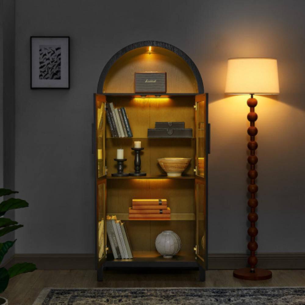 Yellow storage cabinet styled with books and lamp.