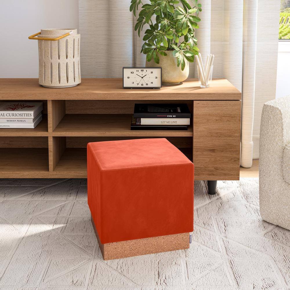 Orange storage ottoman used as a table in a living room.
