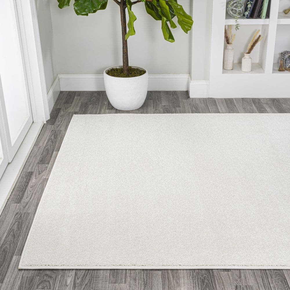 Cream Solid Synthetic Low-Pile Reversible Area Rug 8 x 10
