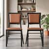Two brown and black foldable dining chairs in a living room setting.