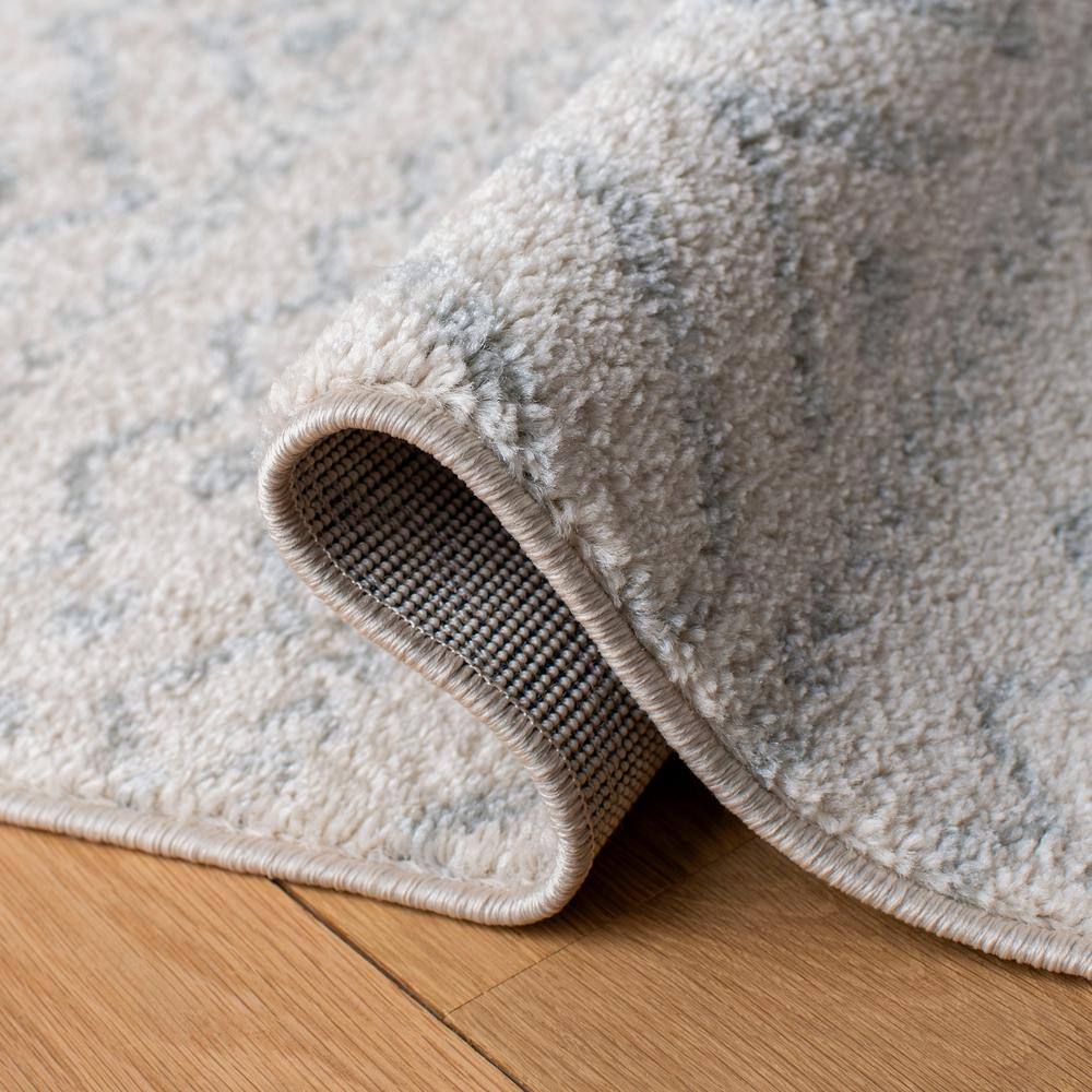 Ivory and Light Grey Geometric 6' x 9' Synthetic Area Rug