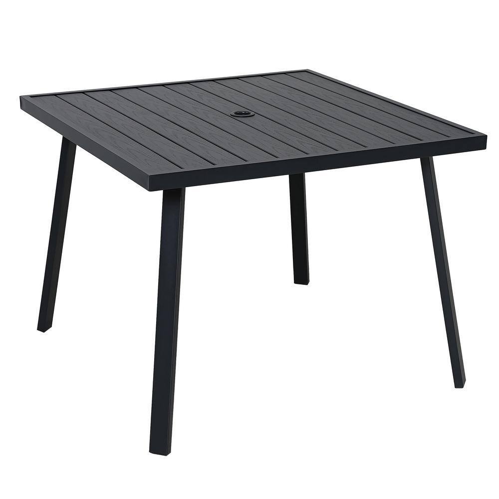 Close-up of the black square slat-top outdoor dining table with an umbrella hole.