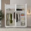 Open wardrobe interior with clothes and storage.