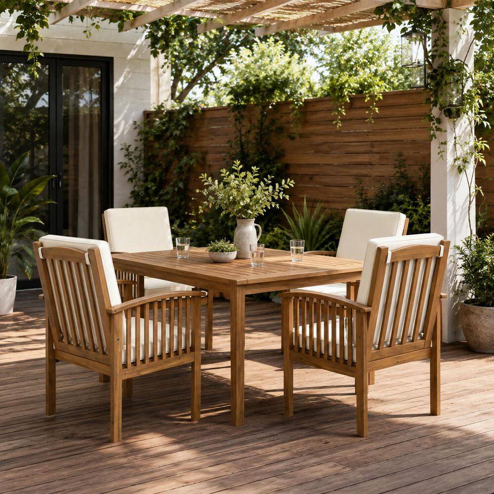 Wooden dining table with four slatted wooden chairs outdoors.