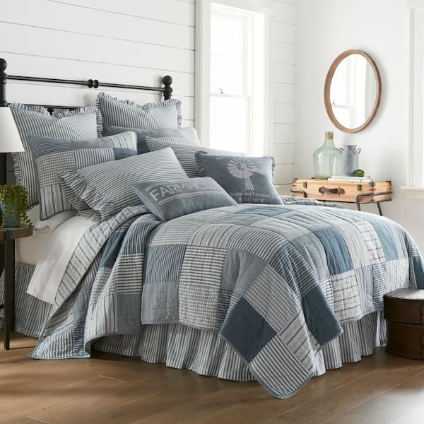 Blue and white patchwork quilt in a charming collected bedroom
