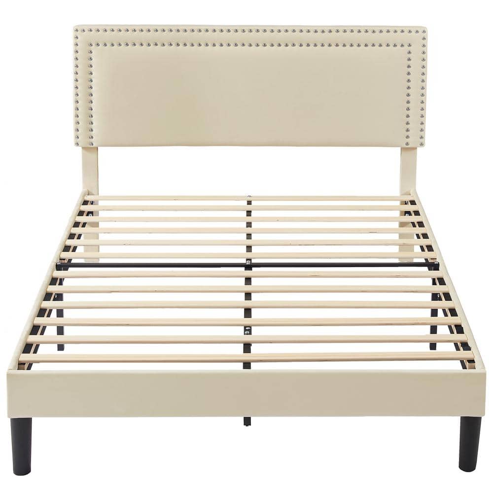 Full view of the beige upholstered bed frame without a mattress.