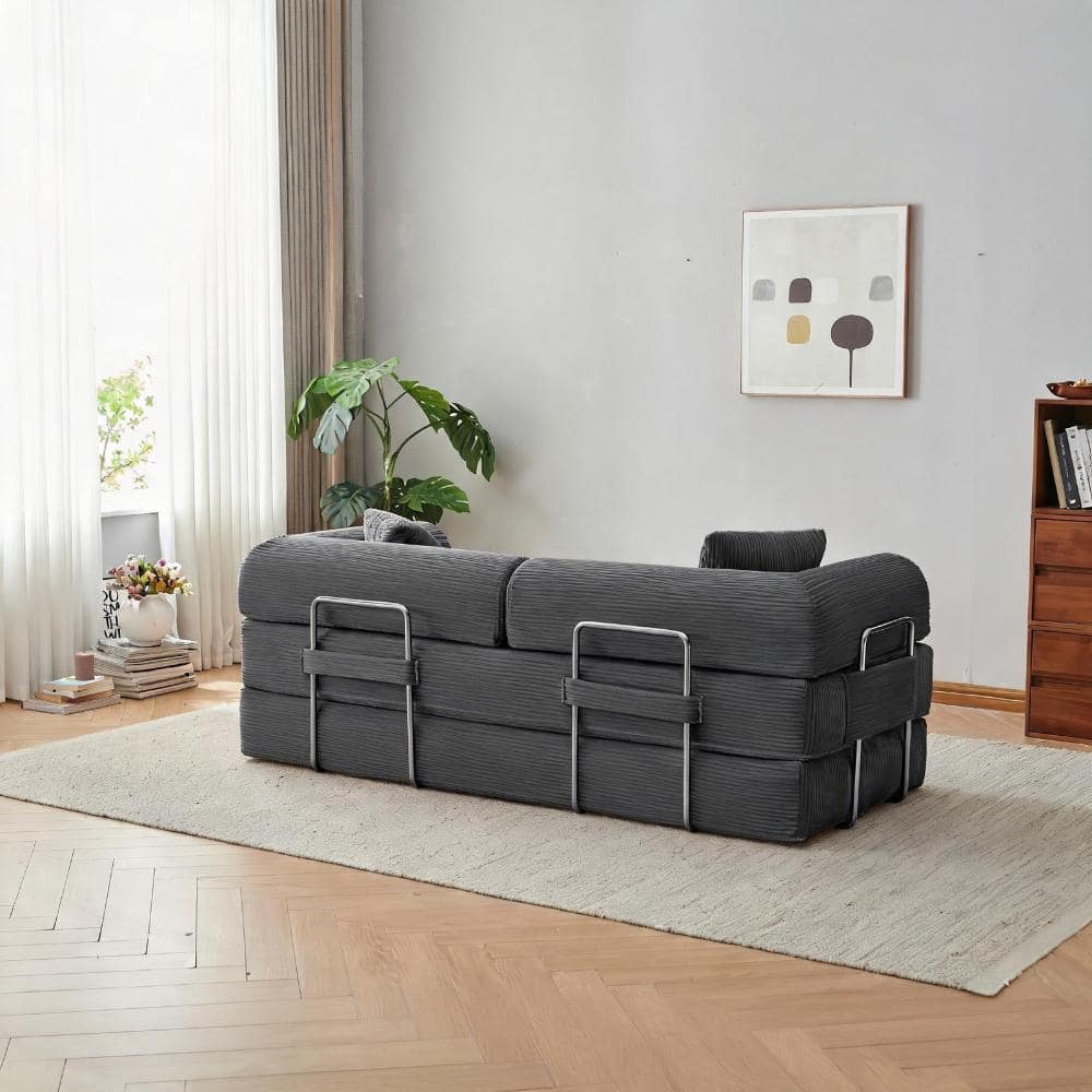 Gray corduroy floor sofa bed in a bright living room.