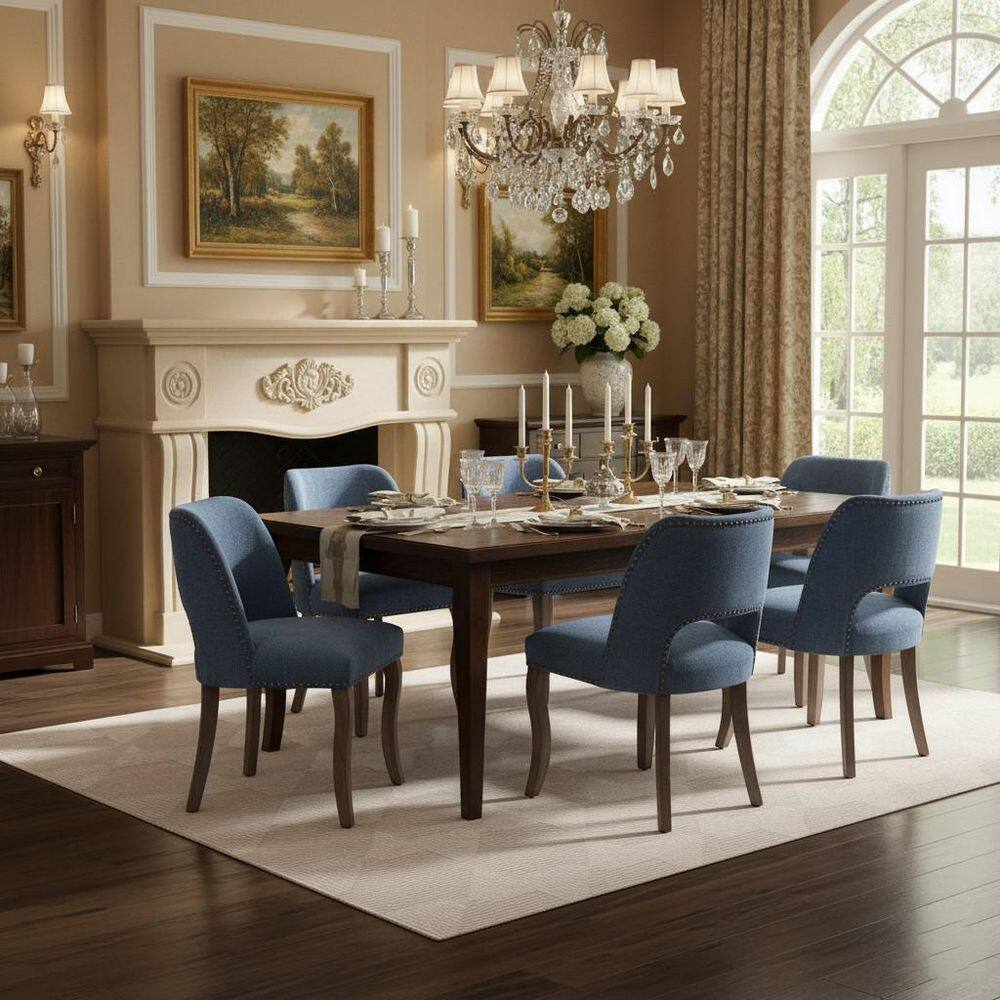 Six denim blue upholstered dining chairs with curved backs arranged around a long dark wood dining table.
