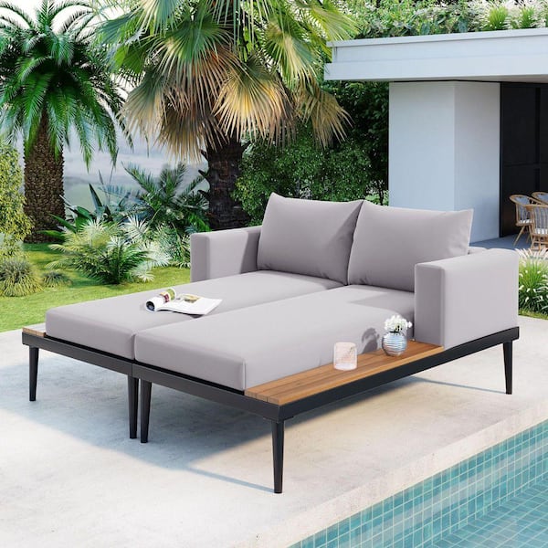 Black Metal Outdoor Day Bed with Gray Cushions and Wood Topped Side Spaces